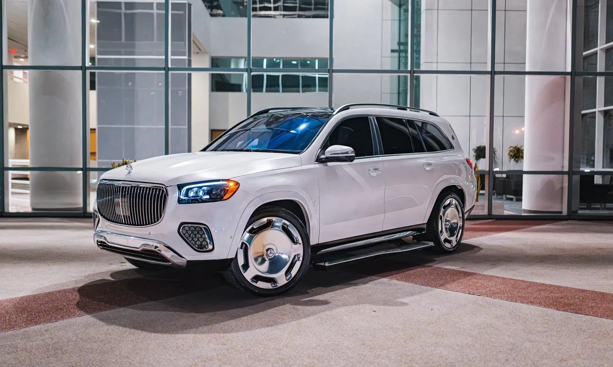 White Mercedes-Maybach GLS 600 in front of a glass building